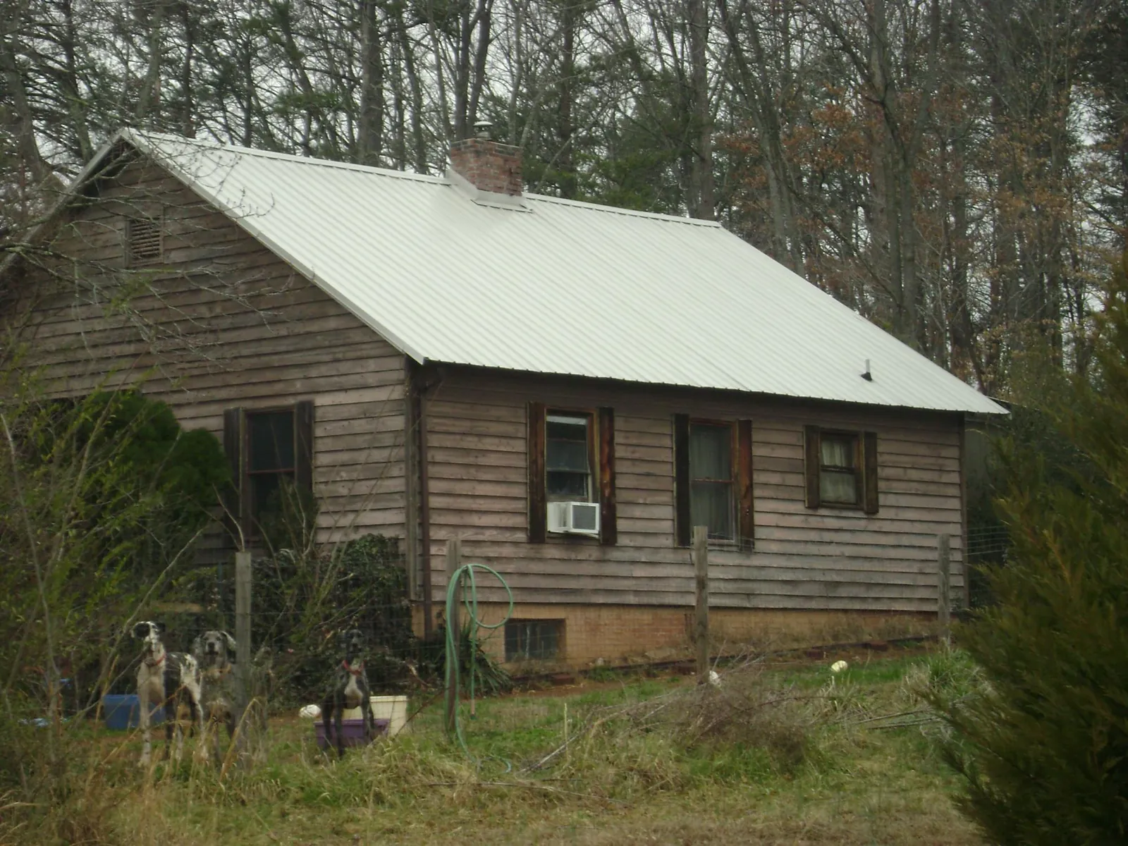 White metal roof on an old wood sided farmhouse, from a Metal Roof Installation job in Smyrna